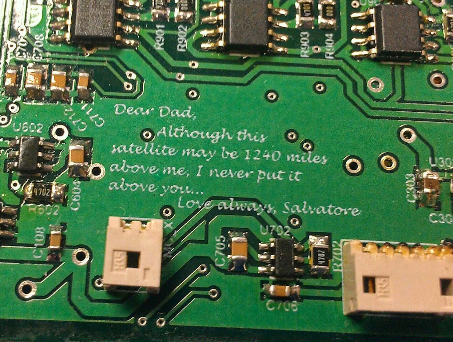 A silkscreen message to Dad engraved on the SwampSat CubeSat motherboard