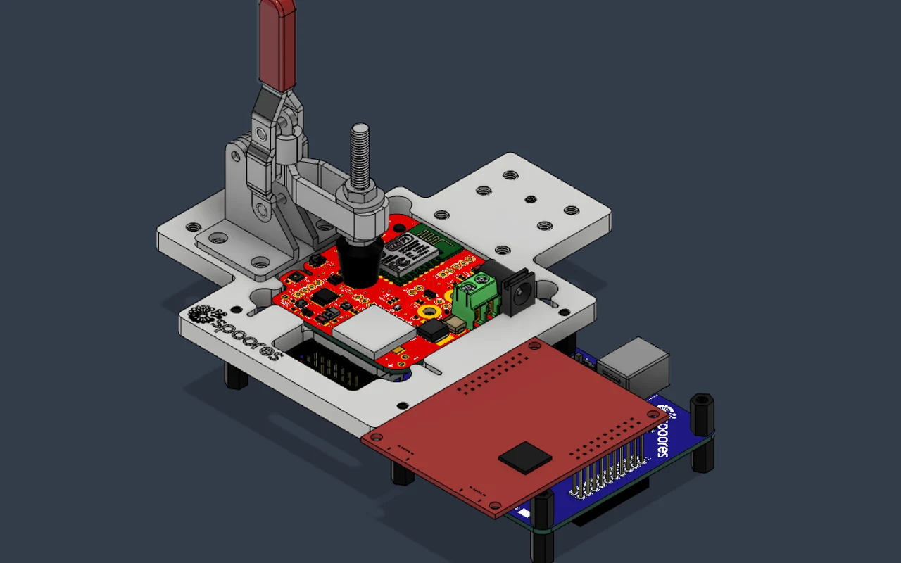 A CAD model of the Spoores programming fixture with a toggle clamp over the board